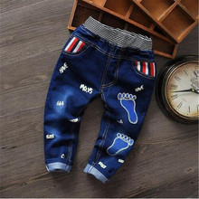 2016 Spring and Autumn children’s cartoon boy footprint washed jeans elastic waistband is spring and autumn baby boy favorite