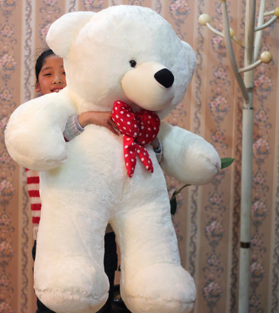 white teddy bear with red bow