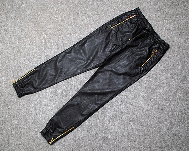 black leather joggers with gold zippers