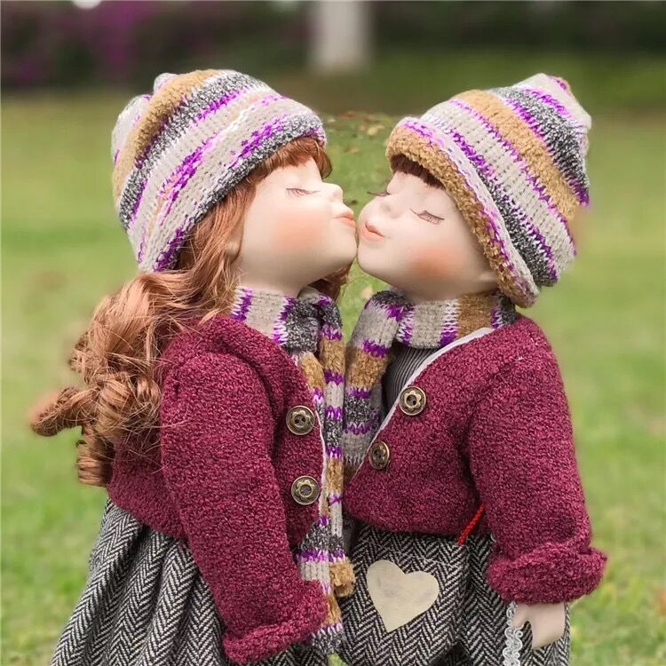 boy and girl kissing porcelain dolls